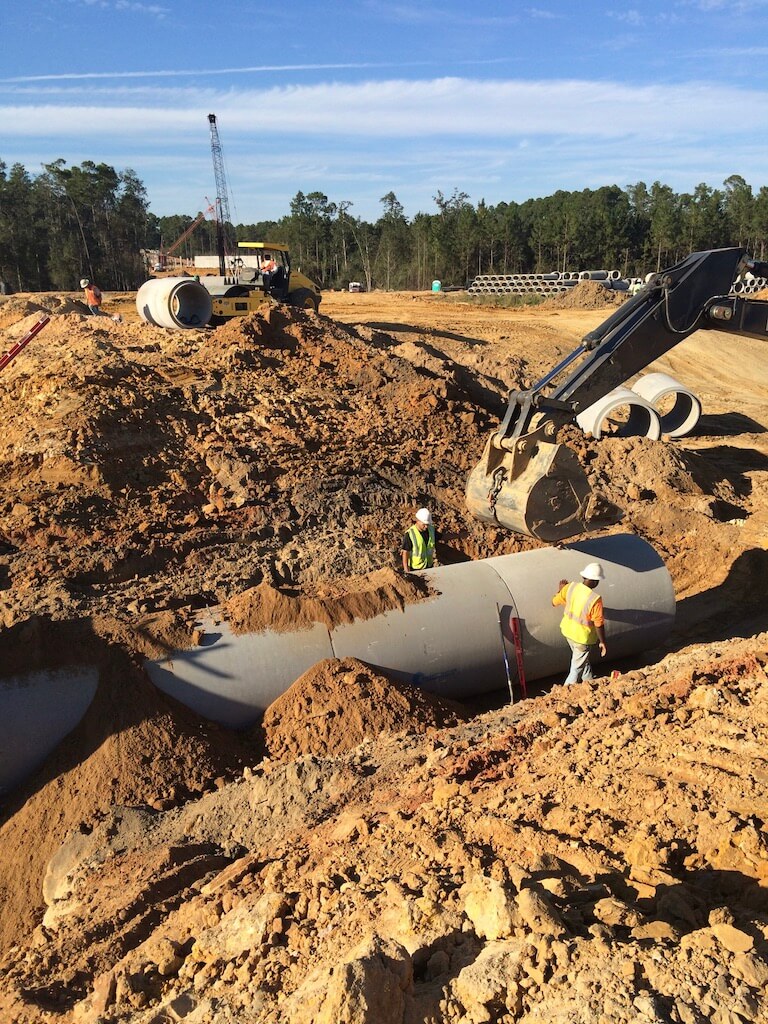 GEC employees installing an underground concrete pipe